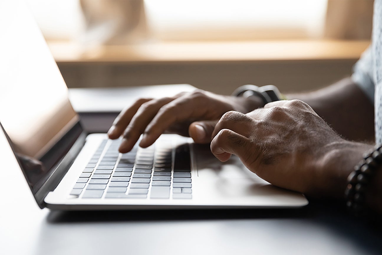 A photo of someone typing on a computer.