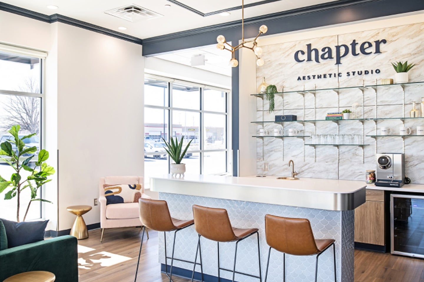 View of the entrance area of Chapter Aesthetic Studio, showing several stools at a counter