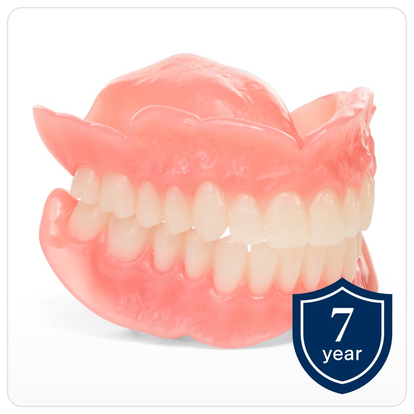 A model of Comfilytes dentures, one of Aspen Dental's most premium full dentures, on a white background. A shield icon on the bottom right with text that reads "7 year" indicating the warranty.