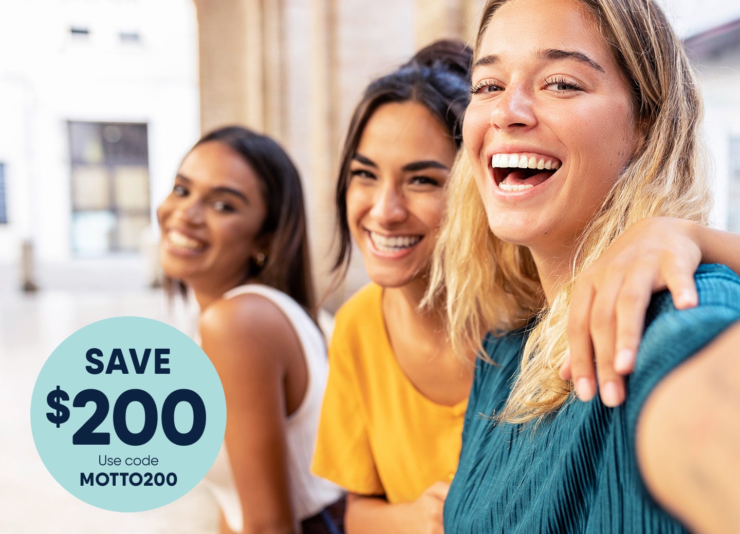 Girls smiling and hugging, promoting Motto Clear Aligners. Text on image reads “Save $200 – Use code MOTTO200.”