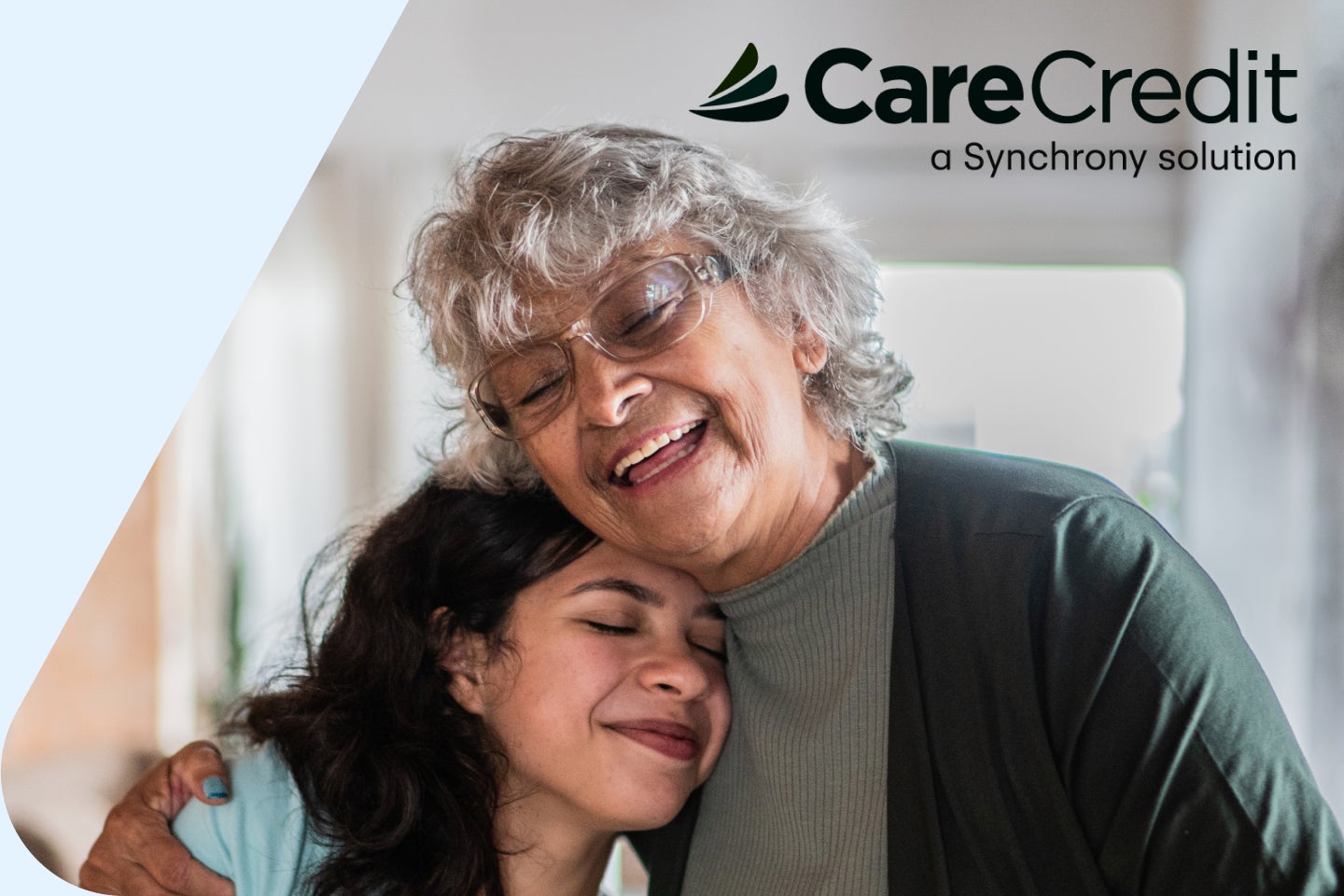 An advertisement for carecredit shows an elderly woman hugging a younger woman