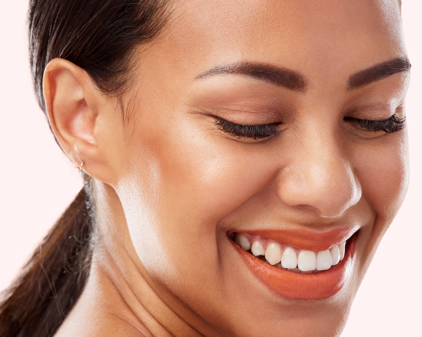 Closeup of a smiling guest after a laser facial treatment.