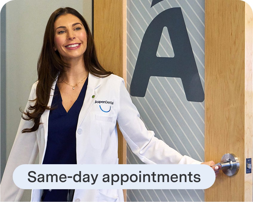 Aspen Dental clinician smiles while welcoming a patient for their visit, highlighting same day appointments.