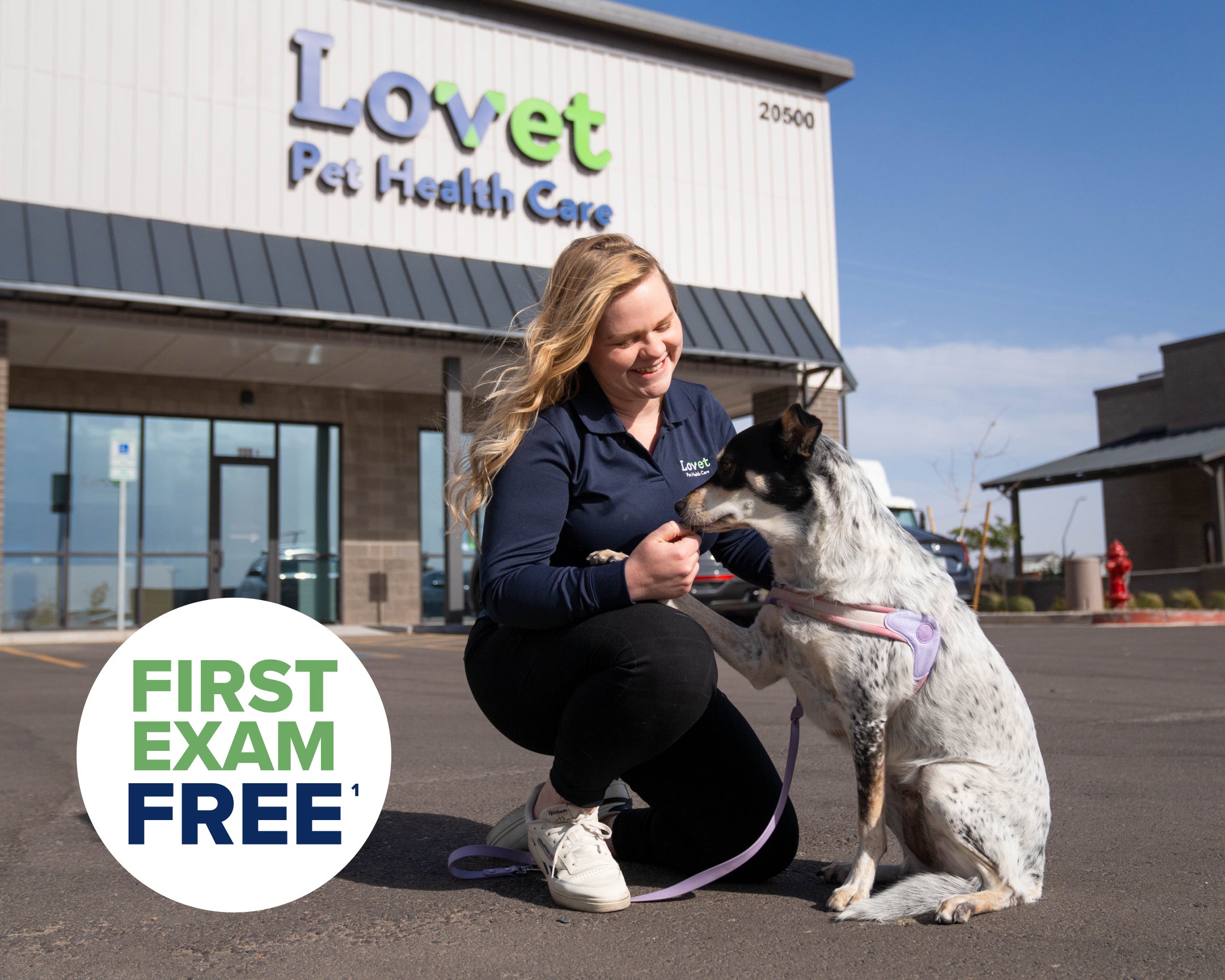 Lovet employee giving dog a treat outside of a Lovet Hospital.