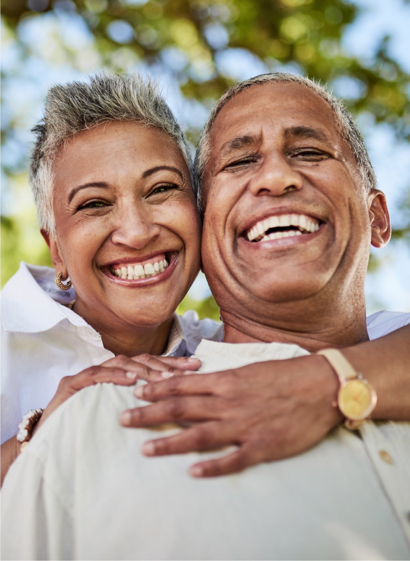 A man and woman are hugging each other and smiling