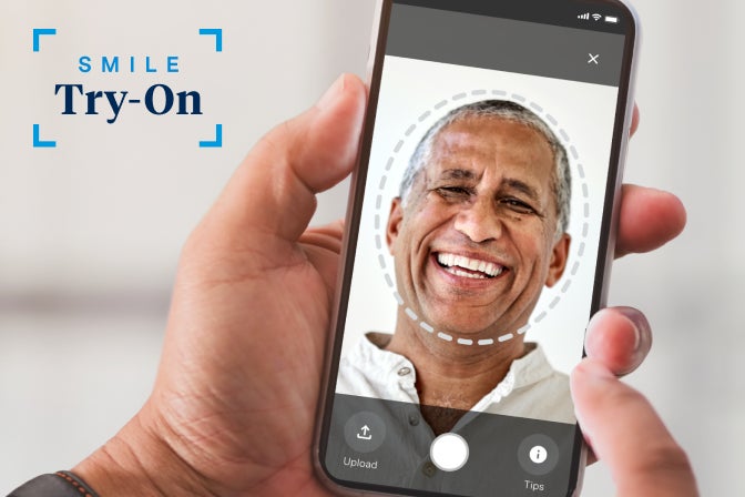 Aspen Dental Smile Try-On - A person is holding a cell phone with a picture of a smiling man on it