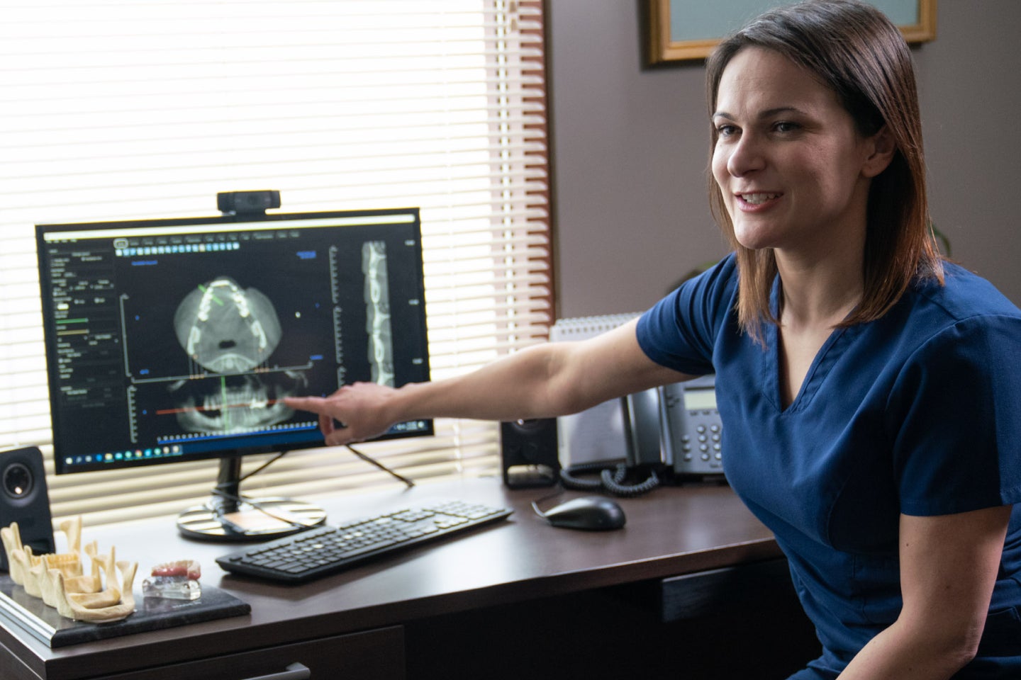 A image of a ClearChoice dental professionsl pointing to a key area on a patient’s xray.