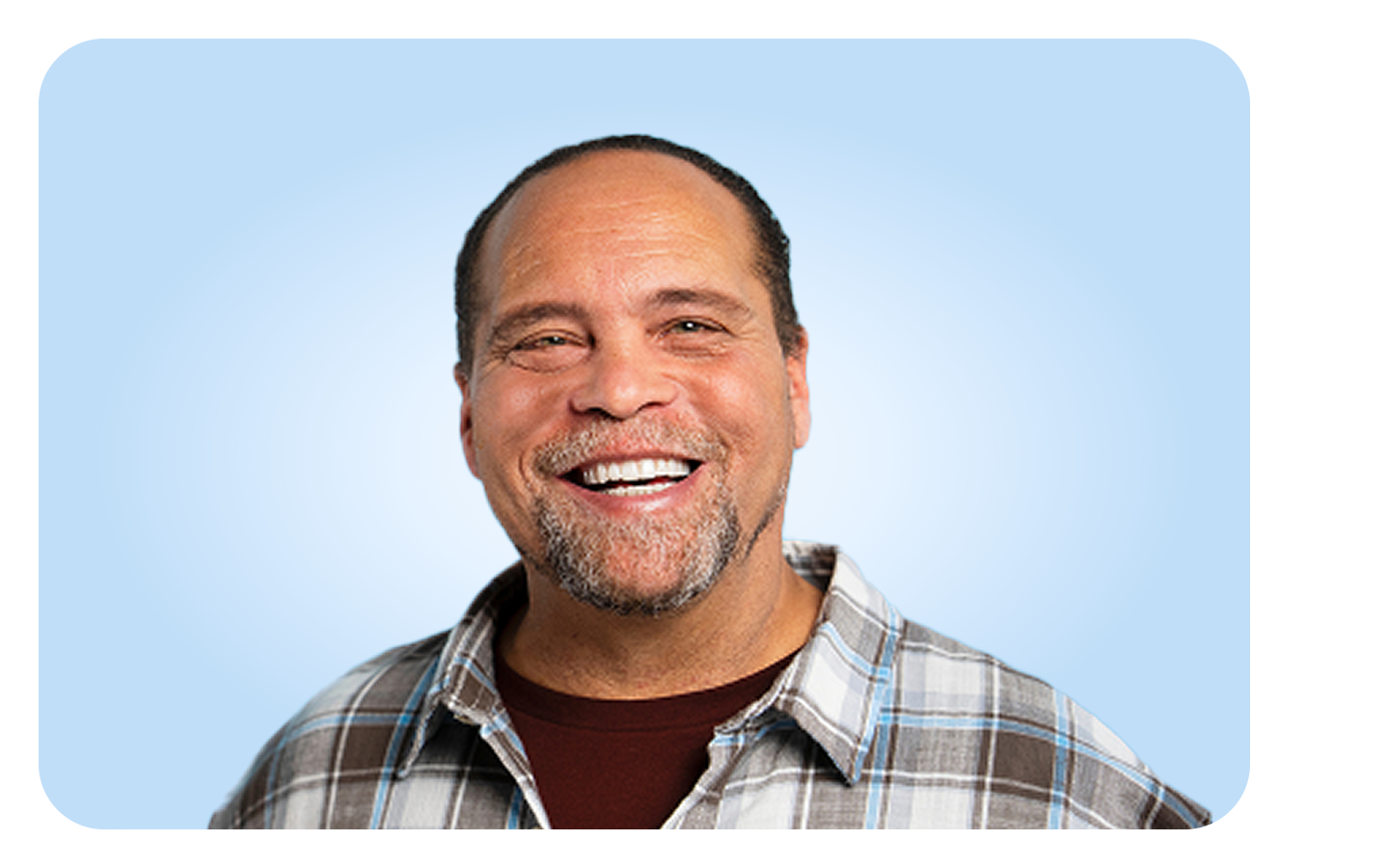  Smiling male showing restored confidence after dental implant treatment at Aspen Dental.