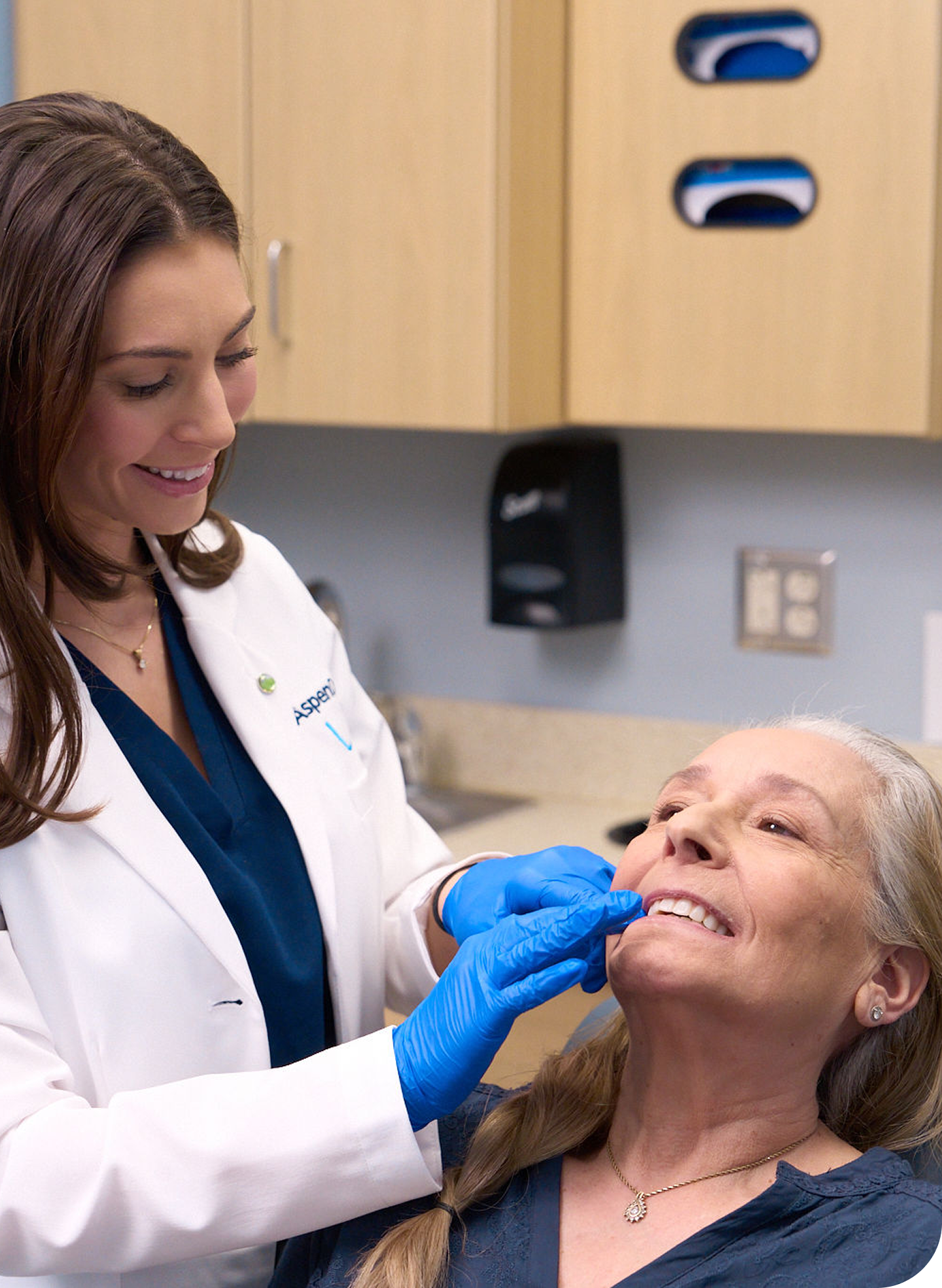 Aspen Dental dentist examines a patient's mouth to discuss whether cavities hurt and explore cavity treatment options.