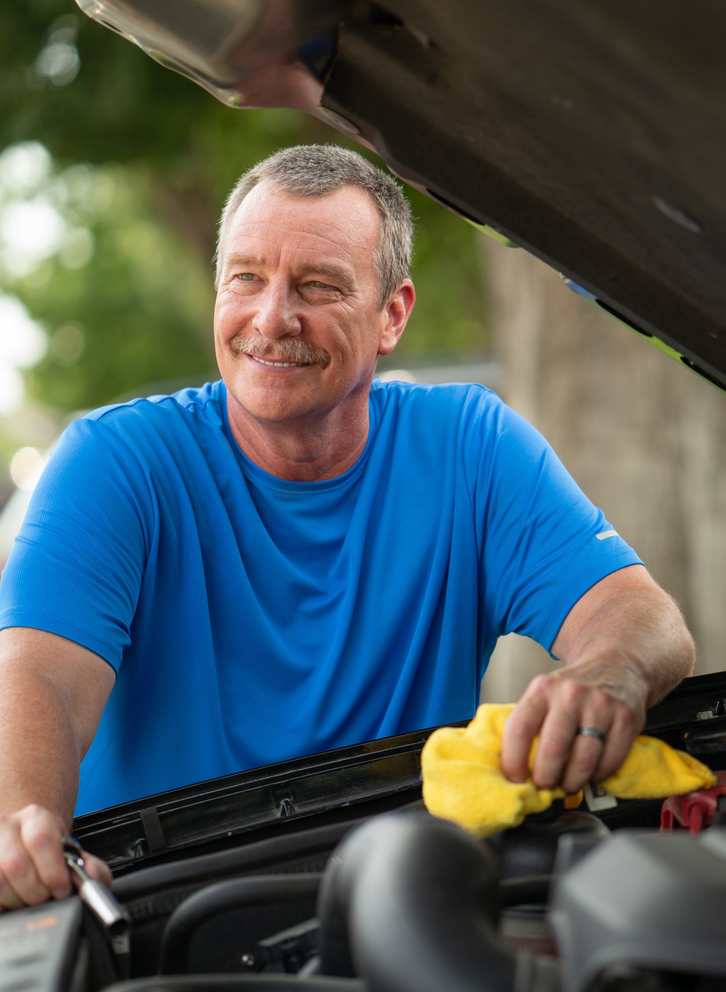 A smiling man outdoors, showcasing his confident smile after a successful dental implant procedure at ClearChoice, emphasizing the importance of proper care to avoid dental implant failure.