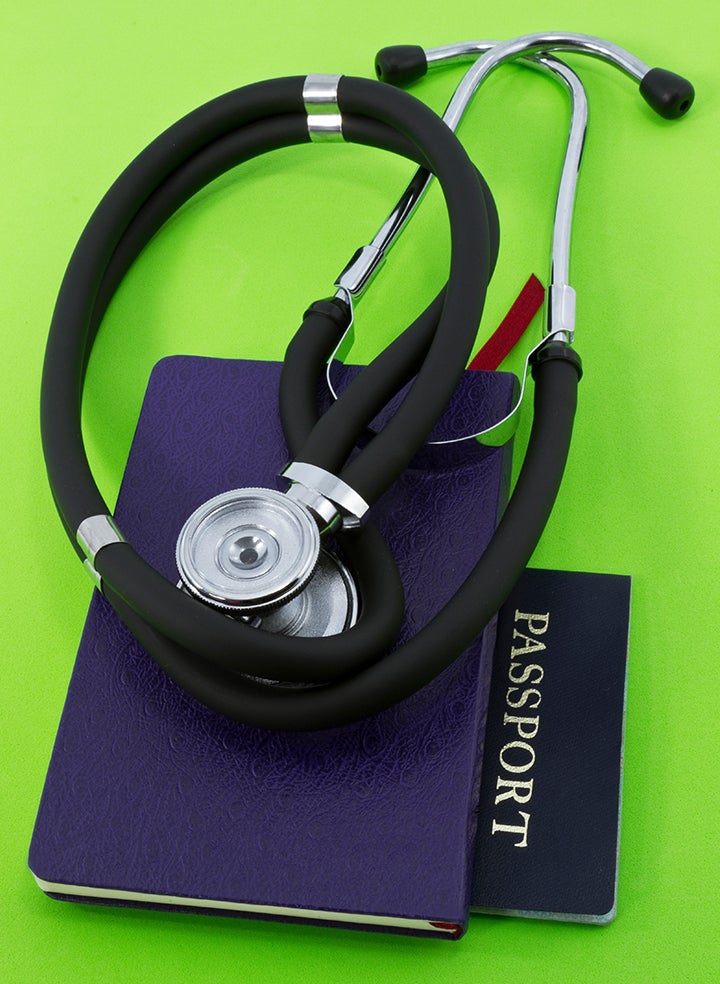 A stethoscope is sitting on top of a passport