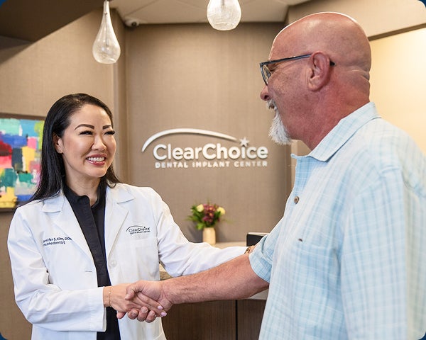 An image of a ClearChoice doctor shaking hands with a satisfied patient in one of the ClearChoice centers.