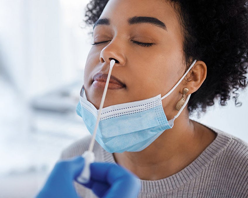 A patient receiving a nasal swab.