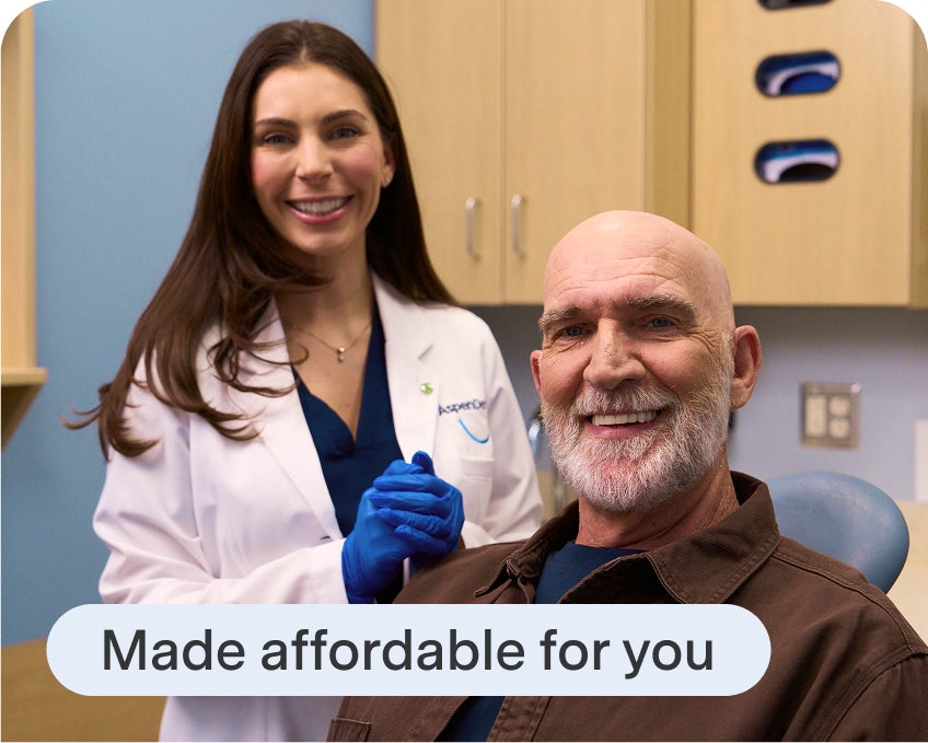 Aspen Dental patient smiles alongside their clinician after finishing their treatment plan, highlighting Aspen Dental affordability.