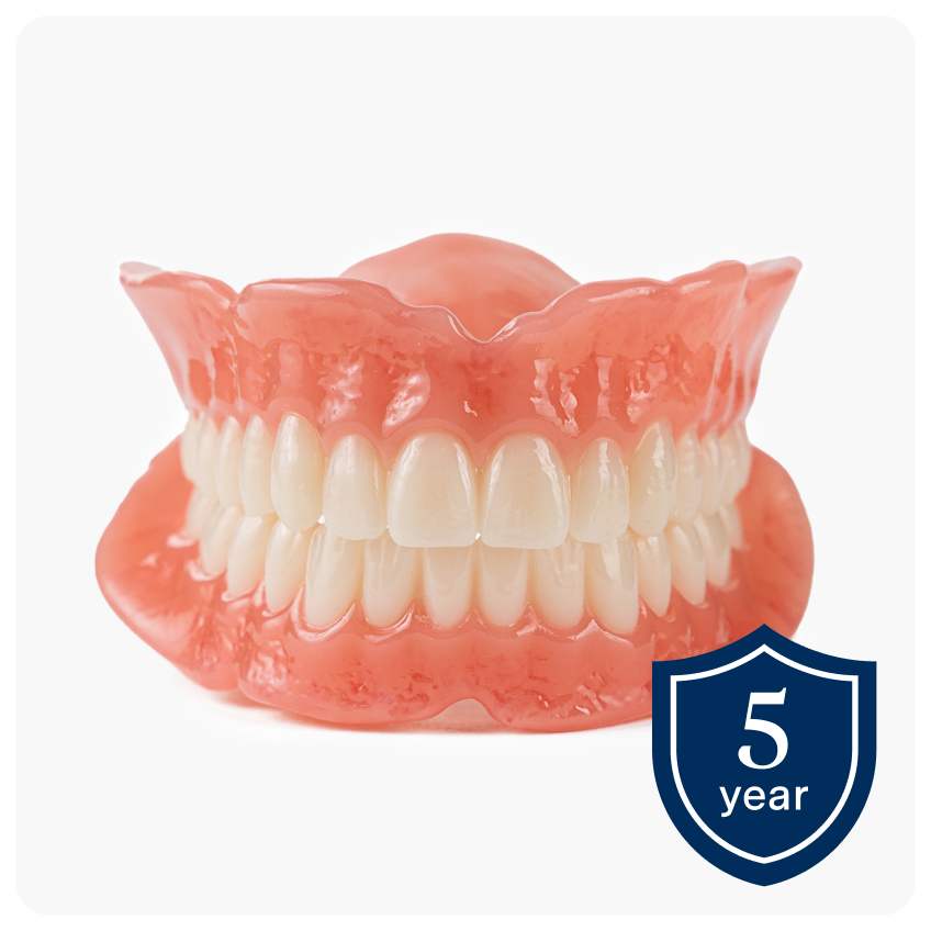 A pair of Aspen Dental Signature dentures showcased on a white background with a 5-year warranty badge in the corner, emphasizing reliable quality and warranty coverage.