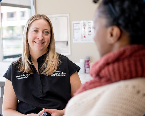 An image of a ClearChoice doctor answering a patient's questions during the initial consultation.