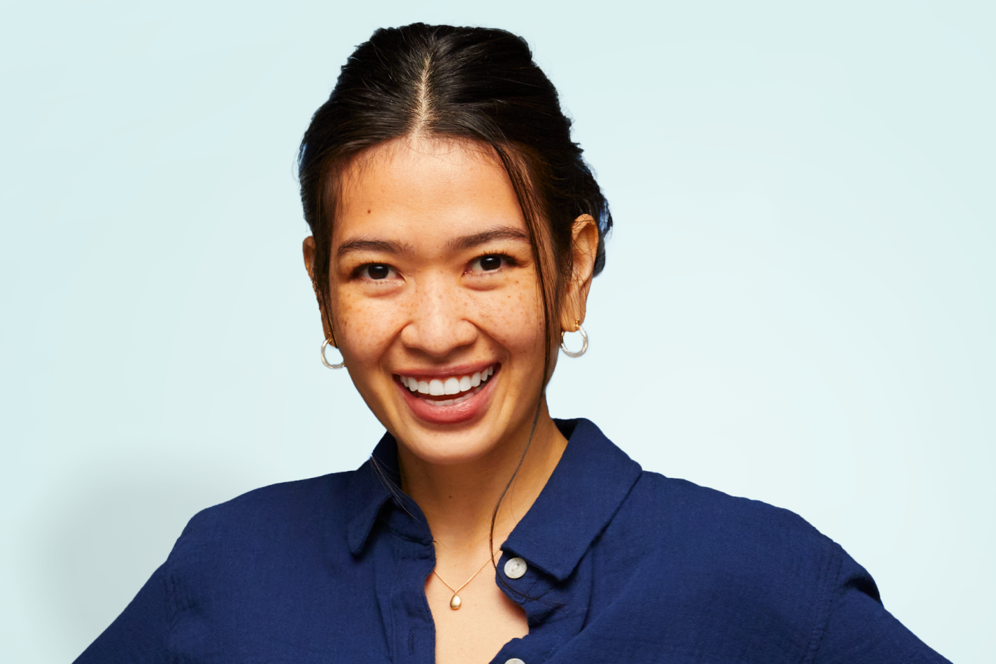 A confident woman smiling brightly, representing the transformative results of Motto clear aligners, which provide straighter, healthier smiles with a natural appearance.