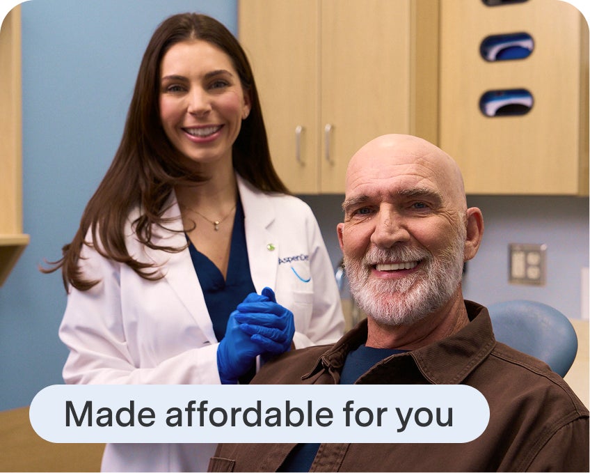 Aspen Dental patient smiles alongside their clinician after finishing their treatment plan, highlighting Aspen Dental affordability.