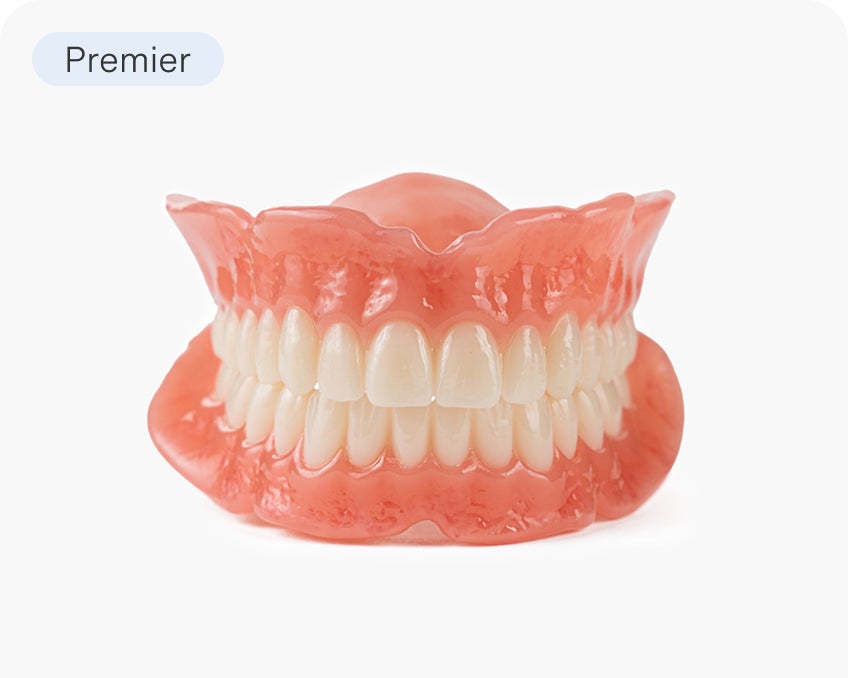  A set of Aspen Dental Signature full arch dentures offering a premium blend of comfort and durability. The image showcases high-quality tooth replacement options.