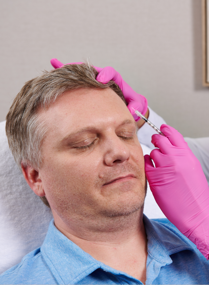 Man receiving Botox treatment at Chapter Aesthetic Studio, demonstrating a cosmetic enhancement procedure in a professional setting.