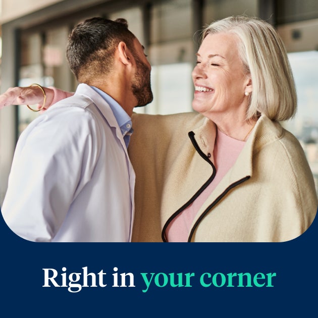 A satisfied patient being warmly welcomed by an Aspen Dental professional, highlighting the compassionate and reliable care offered through the Signature Elite service.