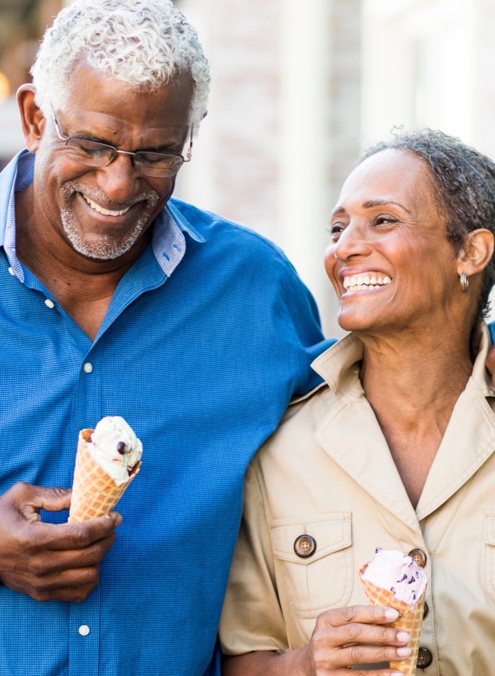 Aspen Dental patients are holding ice cream cones and smiling.
