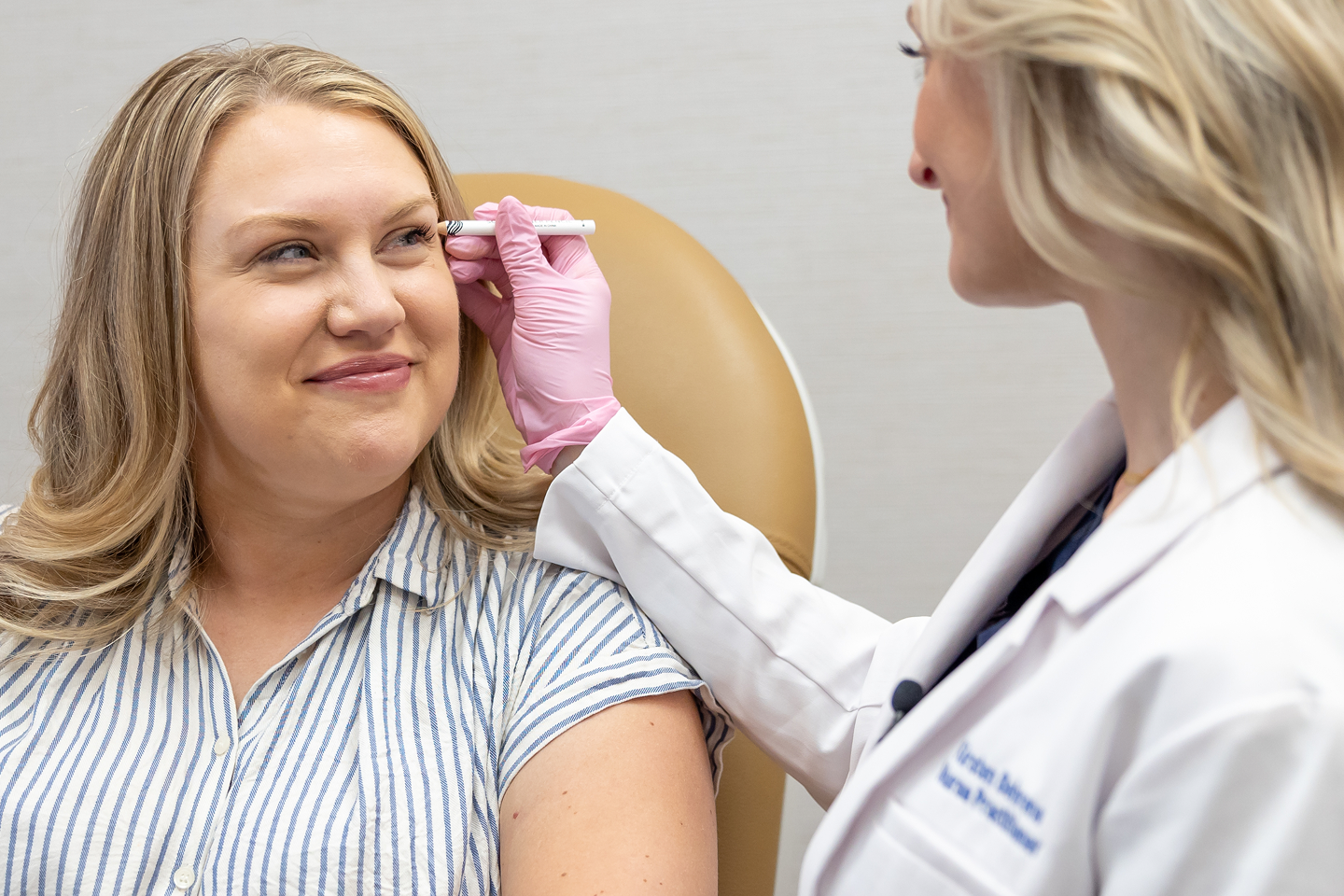 Chapter provider consulting with guest and marking treatment area—illustrating the personalized experience of Xeomin wrinkle relaxer treatment.