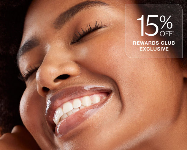 Smiling woman with glowing, hydrated skin gently touching her face—highlighting the benefits of Chapter’s Hydraglow Facial. 