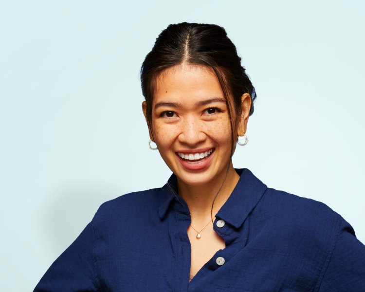 A confident woman smiling brightly, representing the transformative results of Motto clear aligners, which provide straighter, healthier smiles with a natural appearance.