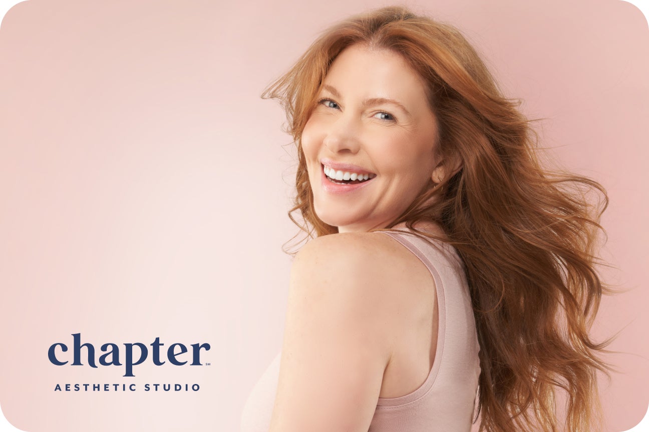 A Chapter Asthetic Studio patient is cheerful and smiling after a positive engagement.