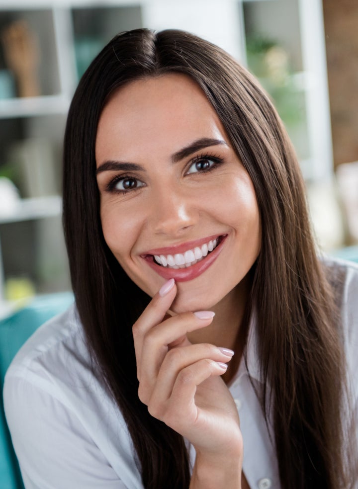 A woman has her teeth examined by a dentist