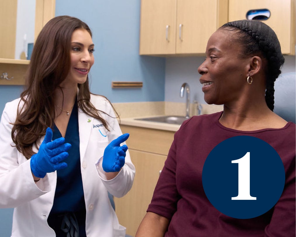 A dental professional talks through the first step of the denture visit with the patient, which is taking full mouth x-rays to understand the patient’s personalized needs.