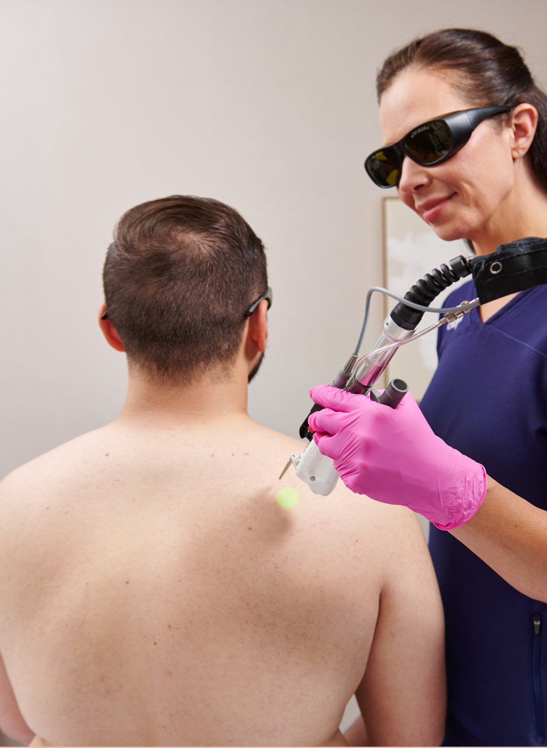 Man undergoing laser hair removal treatment at Chapter Aesthetic Studio, illustrating a professional cosmetic hair removal procedure.