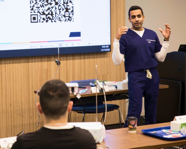 An Aspen Dental professional leading an educational session for veterans and community members as part of the Healthy Mouth Movement initiative.