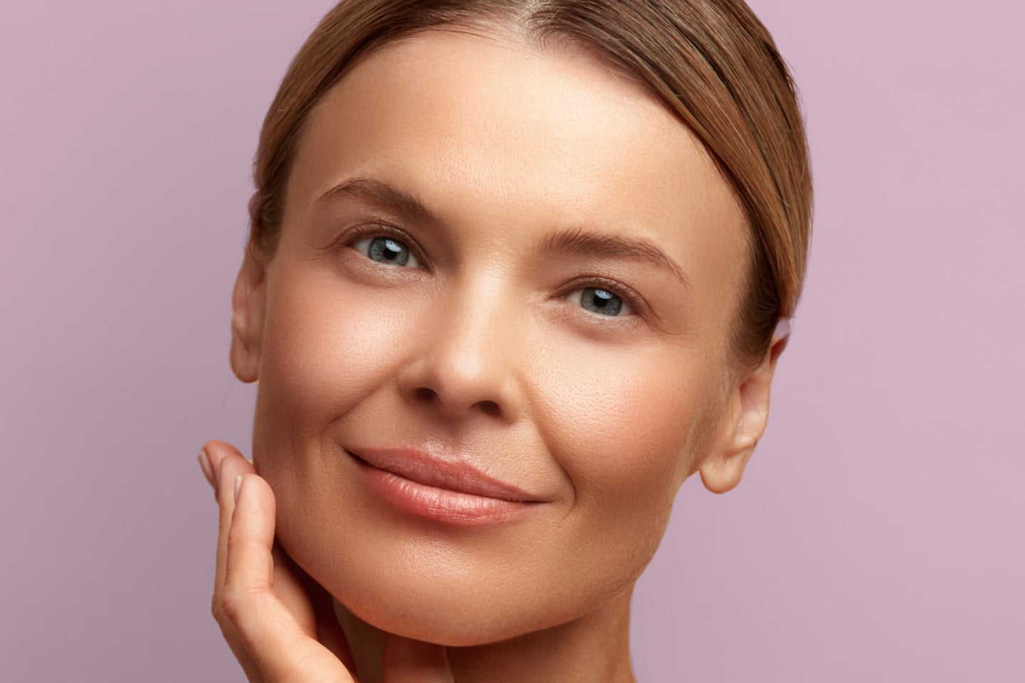 Closeup of a smiling woman after a CoolPeel treatment.