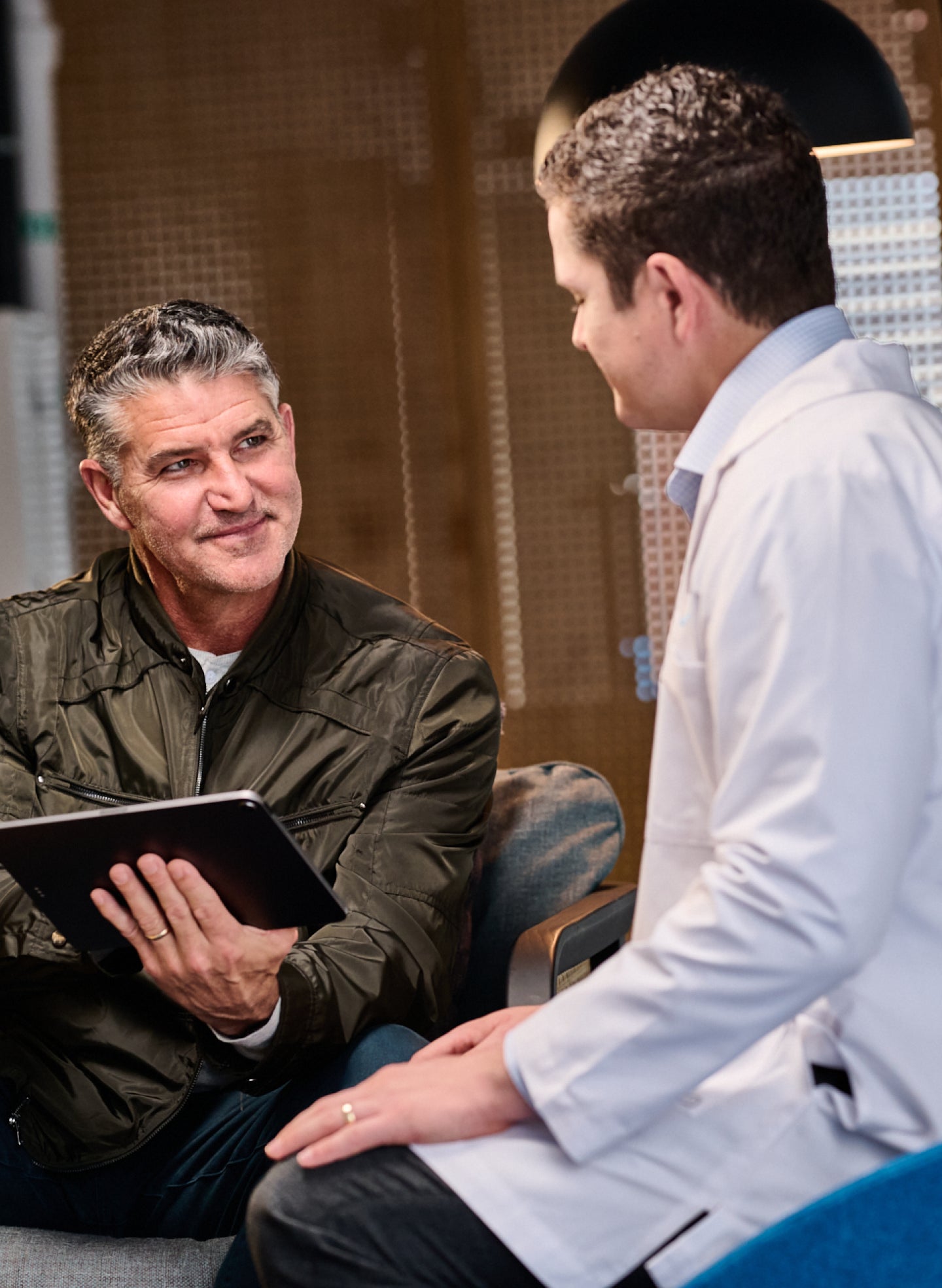 Patient discussing the differences between root canal treatment and tooth filling options with a dental professional at Aspen Dental.