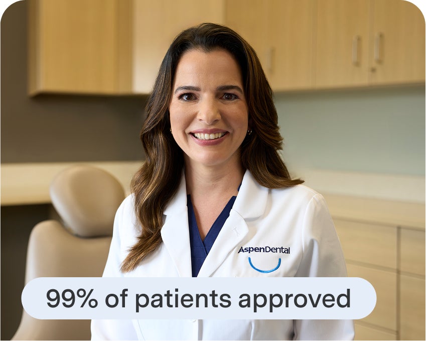 Smiling Aspen Dental provider promotes 99% financing approval for patients seeking affordable implant care.