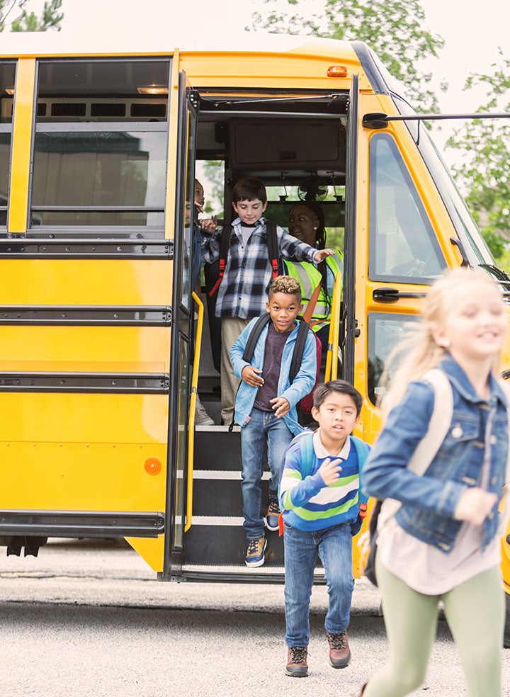 A group of children exiting a school bus. 