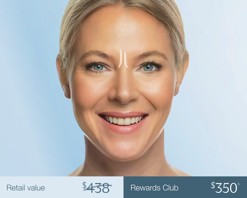 Smiling woman with a treatment mark between the brows—illustrating Chapter’s flat-rate pricing tier for Botox and Xeomin spot treatments like glabellar lines.