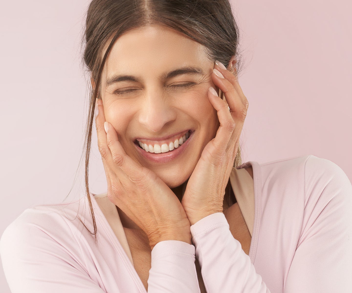 Smiling woman with smooth, glowing skin and eyes closed in joy—encouraging you to book Botox at your local Chapter studio.