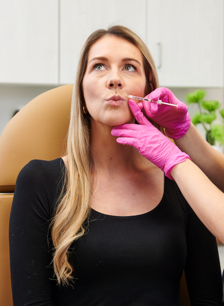 Woman receiving Botox treatment at Chapter Aesthetic studio, showcasing a professional aesthetic procedure in a clinical setting.