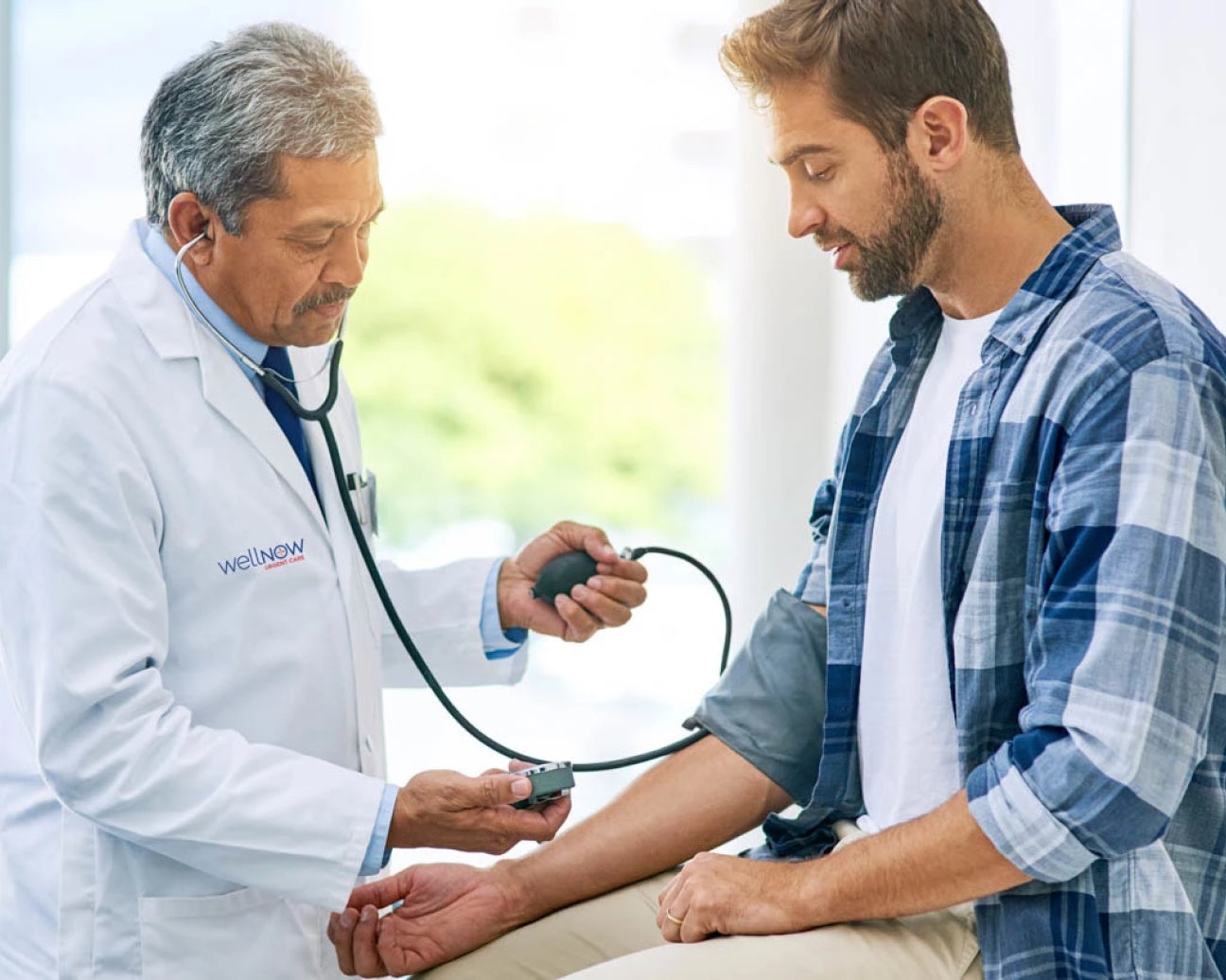 A medical provider checking a patient's blood pressure.