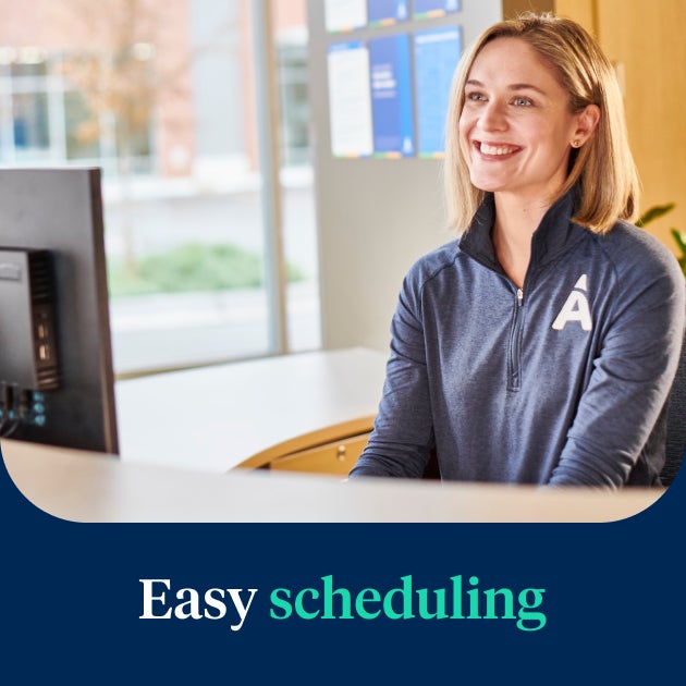  A friendly Aspen Dental receptionist assisting a patient with easy scheduling for the Signature Elite service, ensuring a seamless and convenient appointment process.