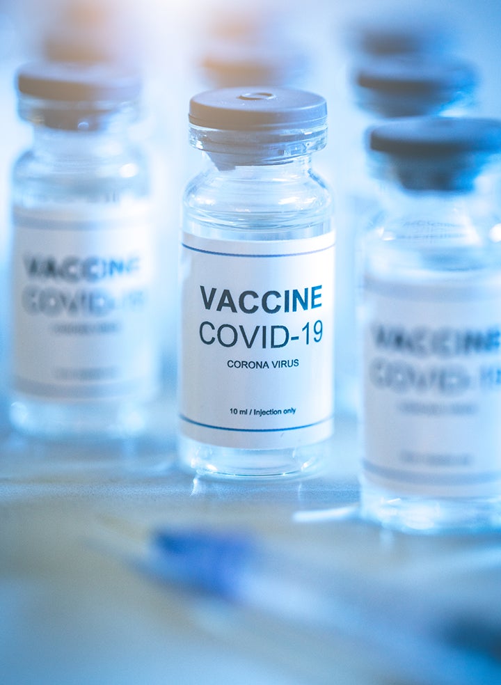 Bottles of vaccine covid-19 sitting on a table