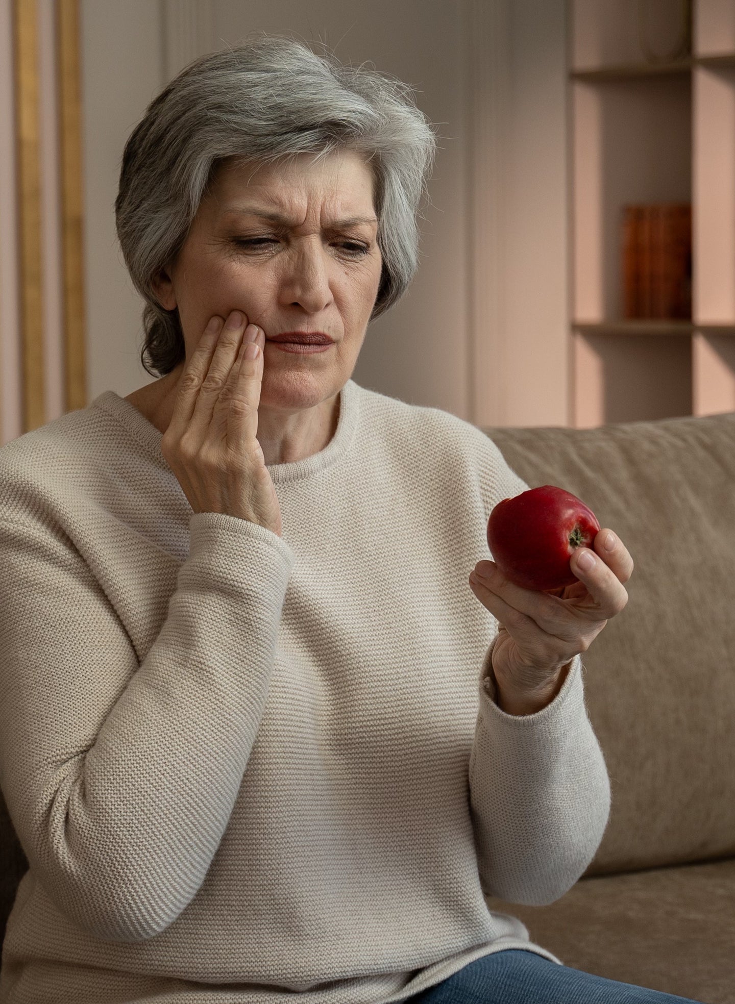 A female patient experiencing pain with her dental implant at home, which could indicate a potential implant infection.