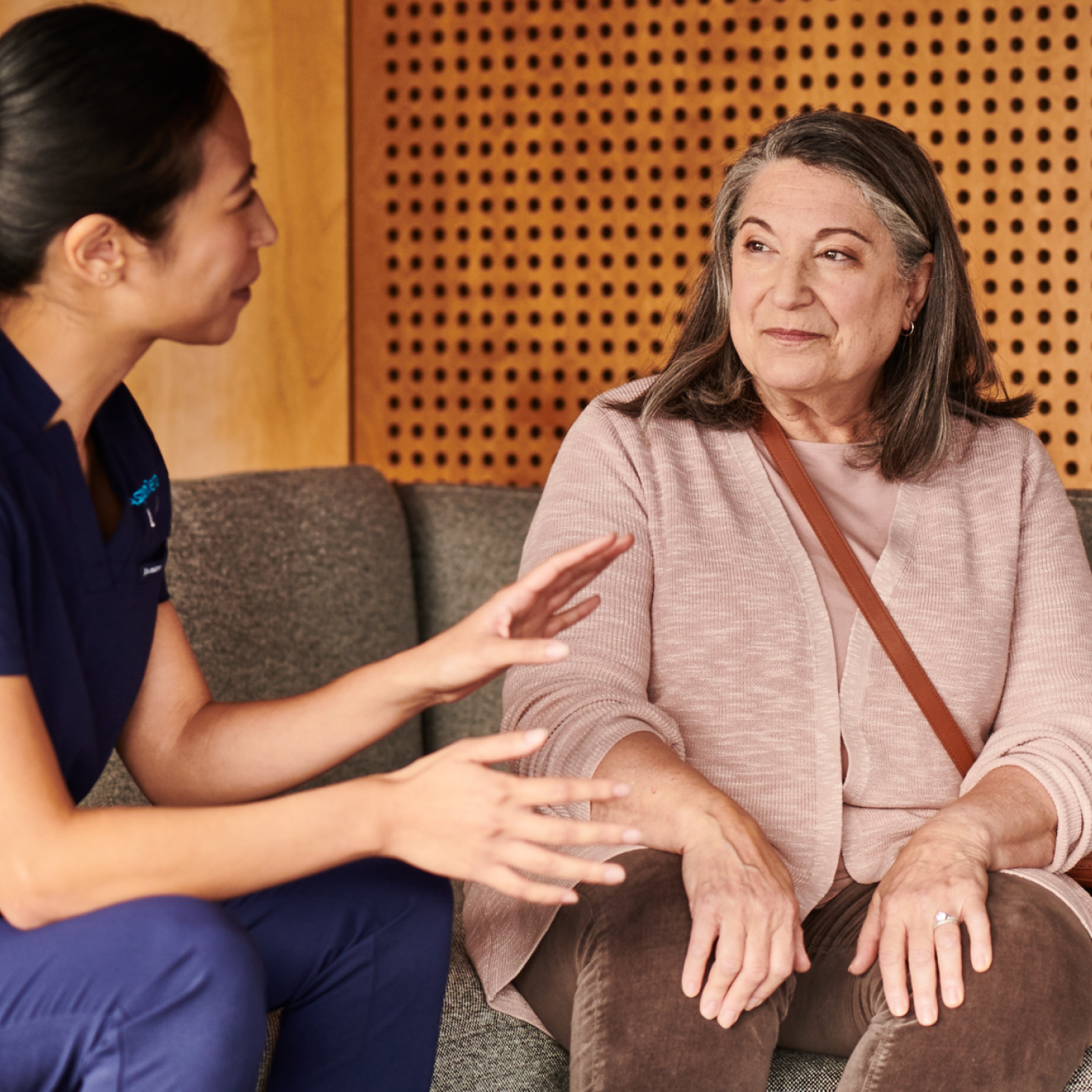 An Aspen Dental professional having a thoughtful consultation with a patient, emphasizing personalized and compassionate dental care.