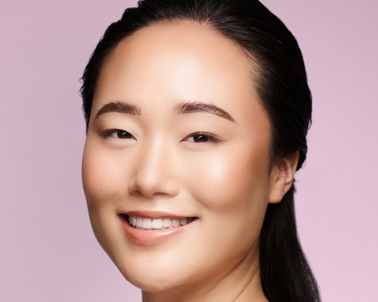 Smiling woman after a dermal filler treatment at Chapter Aesthetic Studio.