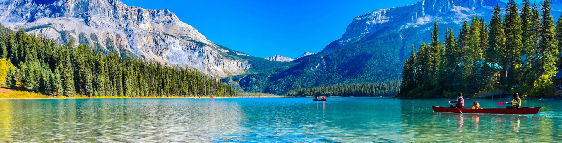 Tranquil Emerald Lake reflecting surrounding forests and Rocky Mountains in Yoho National Park, British Columbia