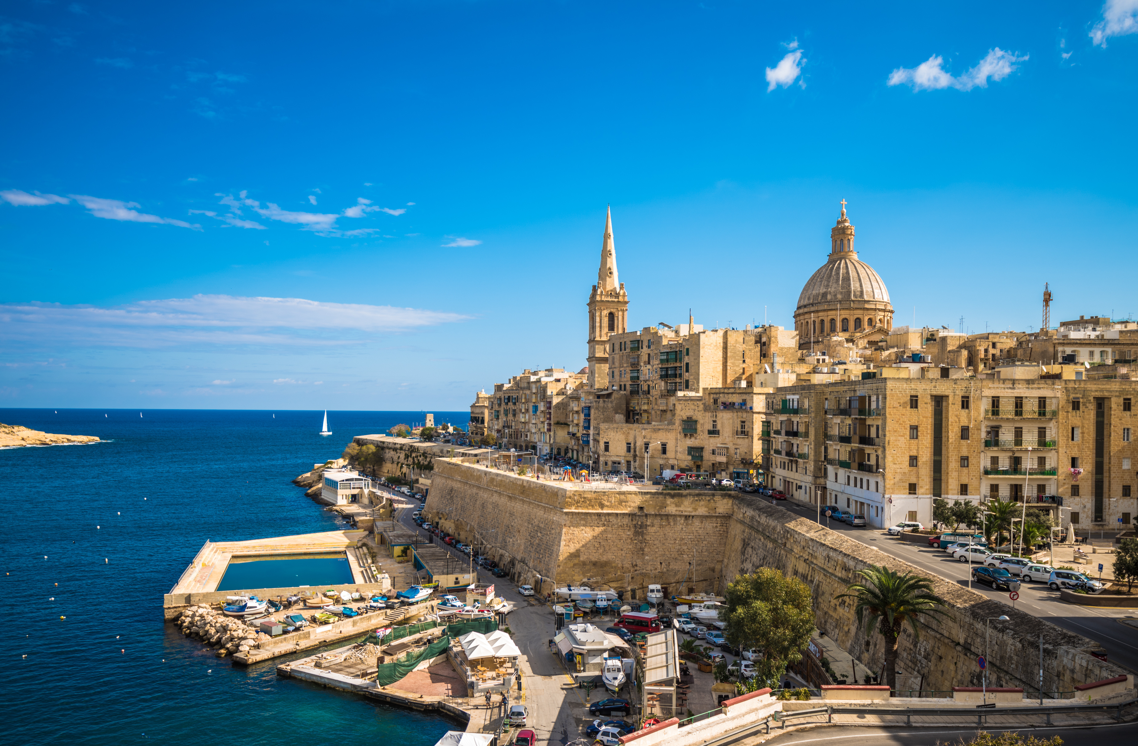 St. Paul’s Bay waterfront in Malta featuring historic buildings including Wignacourt Tower along the coastline