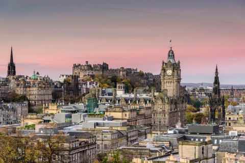Pink sunrise over Edinburgh city center with Edinburgh Castle in the background